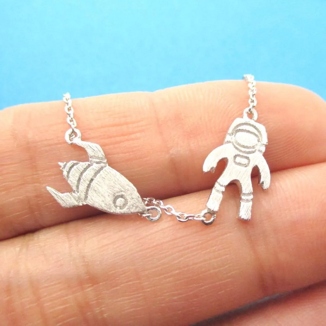 Spaceship and Astronaut Space Travel Themed Charm Necklace in Silver | DOTOLY