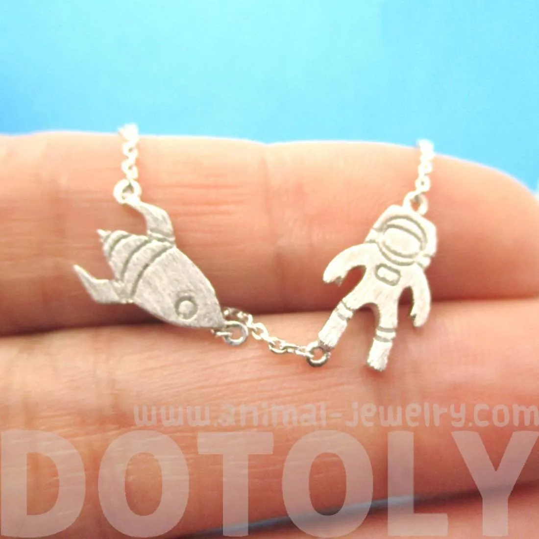 Spaceship and Astronaut Space Travel Themed Charm Necklace in Silver | DOTOLY